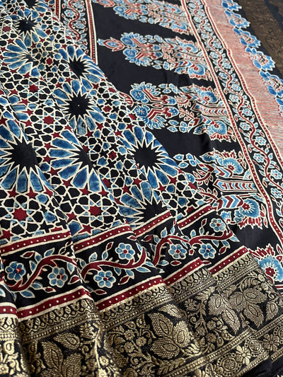 Dreamy Black:Handblock Ajrakh Dola Silk Saree With Meenakari Pallu.